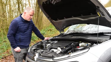 Auto Express executive editor Paul Adam inspecting the Citroen C4 X&#039;s engine bay